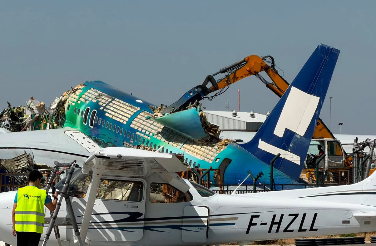Icelandair’s Hekla Aurora Boeing 757 being dismantled behind a parked light aircraft at Lleida–Alguaire Airport.