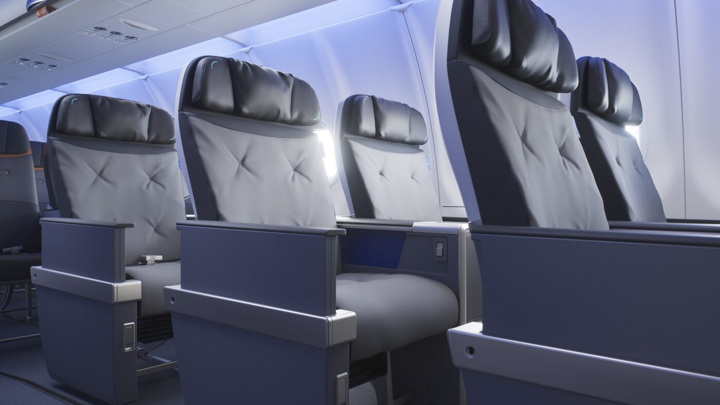 JetBlue BlueFirst cabin with wide gray and navy seats arranged in a 2-2 layout.