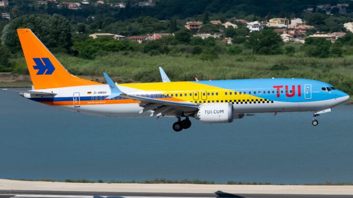 TUI Boeing 737 MAX 8 D-AMAH approaching a runway over water, wearing a blue, yellow and orange special livery.