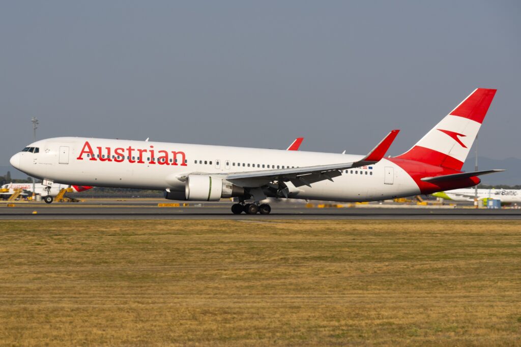 Austrian Airlines Boeing 767-300ER OE-LAE landing with its main wheels on the runway and nose raised.