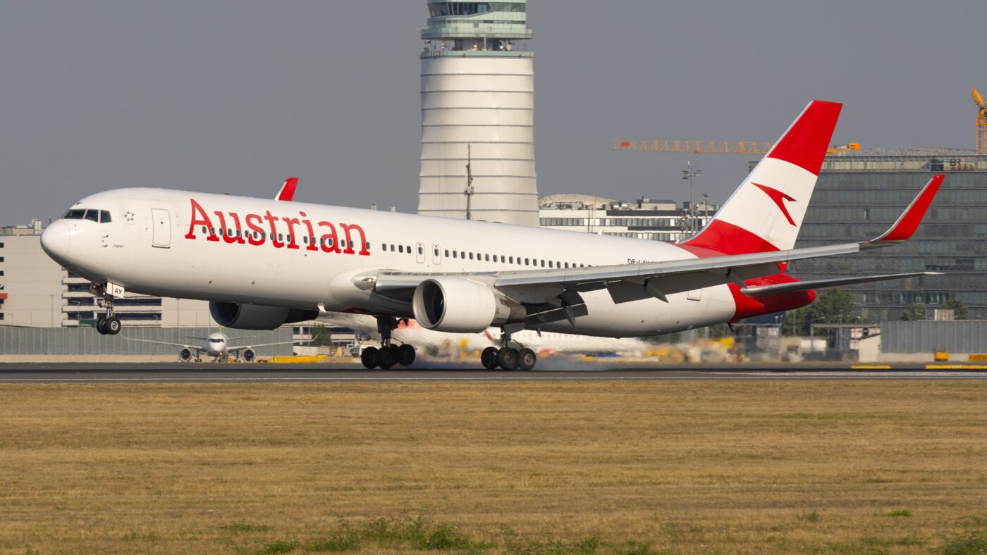 Austrian Airlines Boeing 767-300ER OE-LAY touching down with tyre smoke beneath its main landing gear.