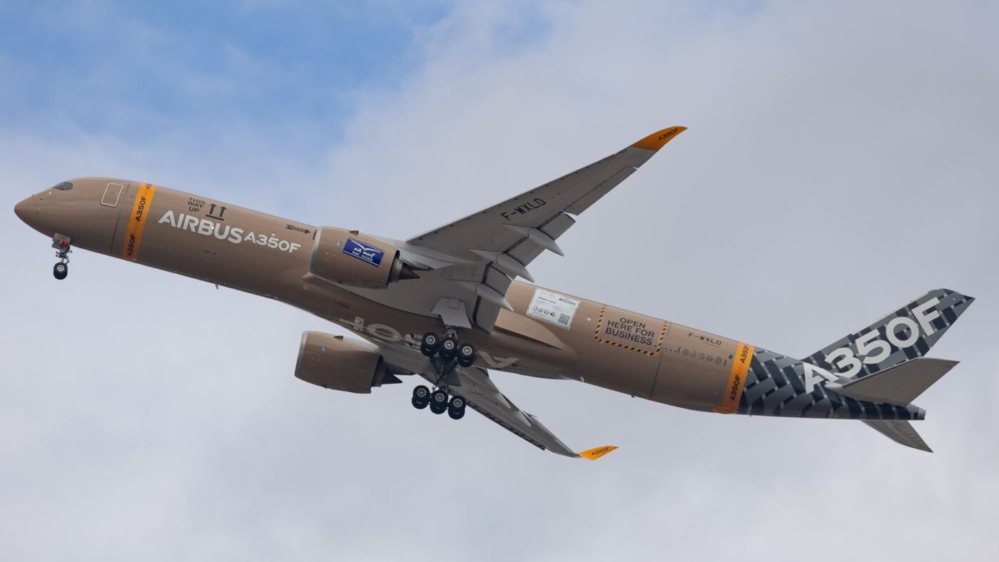 Airbus A350F Completes First Flight as New Freighter Returns to Toulouse The Airbus A350F has completed its maiden flight, returning to Toulouse-Blagnac on 29 September and beginning the flight-test programme for the manufacturer’s new long-haul freighter. The first prototype, MSN700, registered F-WXLD, departed Toulouse earlier in the day. The milestone brings Airbus closer to certification and customer deliveries, currently targeted for the second half of 2027. Two aircraft for the test campaign Airbus plans a campaign involving two aircraft, approximately 400 flight hours and around nine months of testing. MSN700 will focus on aerodynamics, handling and autopilot performance, while MSN701 will cover systems testing and operations in hot and cold conditions. Although based on the passenger A350, the freighter has a distinct configuration. Its fuselage length falls between the A350-900 and A350-1000, while its wing comes from the larger variant. These differences require Airbus to validate the aircraft’s handling and flight-control characteristics. Before taking to the skies, crews rehearsed using a development simulator connected to real aircraft avionics. The prototype also completed high-speed rejected-takeoff tests on 24 September. Before its maiden flight, the A350F prototype completed high-speed rejected-takeoff tests at Toulouse on 24 September. Image Credit: [Photographer] Capacity for 111 tonnes of cargo Powered by two Rolls-Royce Trent XWB-97 engines, the A350F is designed to carry up to 111 tonnes of payload. Its main deck accommodates 30 containers, with further capacity below. A defining feature is its rear main-deck cargo door, which has a clear opening 4.3 metres wide and 3.15 metres high. Airbus describes it as the largest in the industry, designed to simplify loading standard containers and oversized freight. MSN700 carries a packaging-inspired livery developed from winning entries in Airbus’s public design competition, giving the prototype the appearance of a giant parcel. Deliveries targeted for 2027 The programme entered its first-flight campaign with 115 firm orders. Launched in 2021, the A350F was originally intended to enter service in 2025 before development delays pushed deliveries back. Atlas Air ordered 20 aircraft in March 2026, becoming the largest customer at that announcement. The maiden flight now shifts attention to certification. Airbus must demonstrate the aircraft’s performance, systems and cargo-handling capabilities before the freighter can begin commercial operations.
