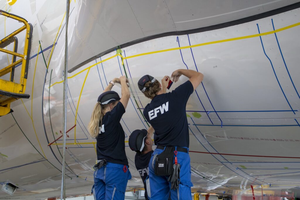 Technicians manually apply AeroSHARK film to the Airbus A330, a precise and labor-intensive installation process. Photo: Carl