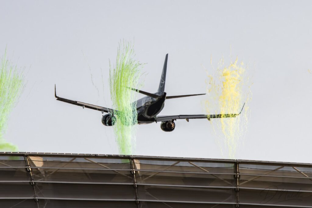 ZS-YDE, an Embraer E190, pilots through the discharged pyrotechnics at DHL Stadium | Image Credit: Dhiav Naidoo | Aviation24n