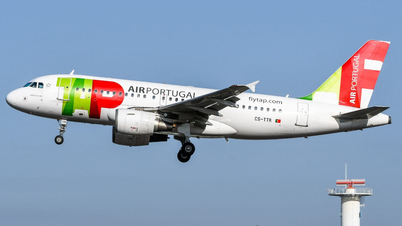 TAP Air Portugal Airbus A319, registered CS-TTR, approaching landing with its landing gear extended against a blue sky.