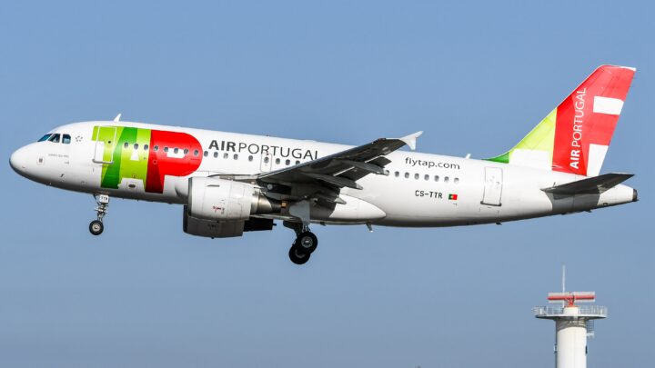 TAP Air Portugal Airbus A319, registered CS-TTR, approaching landing with its landing gear extended against a blue sky.