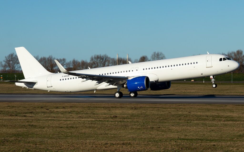 Airbus A321XLR F-WHUE in white test livery with blue engines during runway operations.